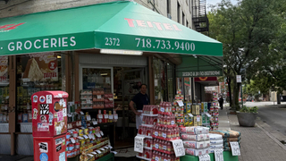 Teitel Brothers Wholesale Grocery on Arthur Avenue and 186th Street. Eddie Teitel stands by the entrance.