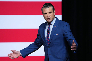 A clean-shaven Pete Hegseth speaks to senior military leaders at Marine Corps Base Quantico in Virginia Sept. 30.