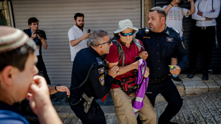 Israeli border police officers forcibly remove a left-wing activist from Jerusalem's Old City during Jerusalem Day celebrations on May 14, 2026 in the Old City of Jerusalem.