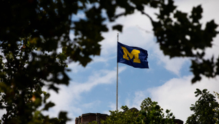 A University of Michigan flag on the Michigan Union building on campus in Ann Arbor, Michigan.