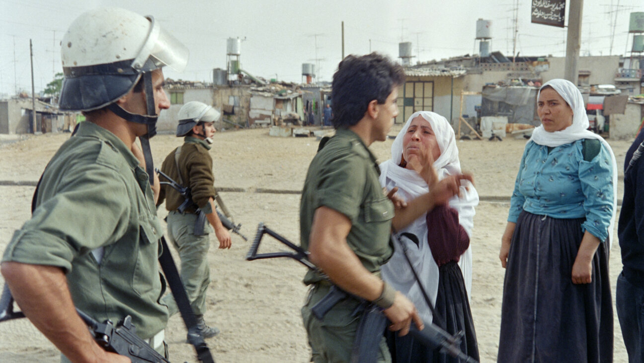 Israeli soldiers argue with Palestinian women in Jabalya refugee camp on December 09, 1987 after a curfew was imposed following violent demonstrations in the Gaza strip. The First Intifada, a Palestinian uprising against the Israeli occupation of the Palestinian Territories erupted in the Jabalia refugee camp and quickly spread throughout Gaza, the West Bank and East Jerusalem.