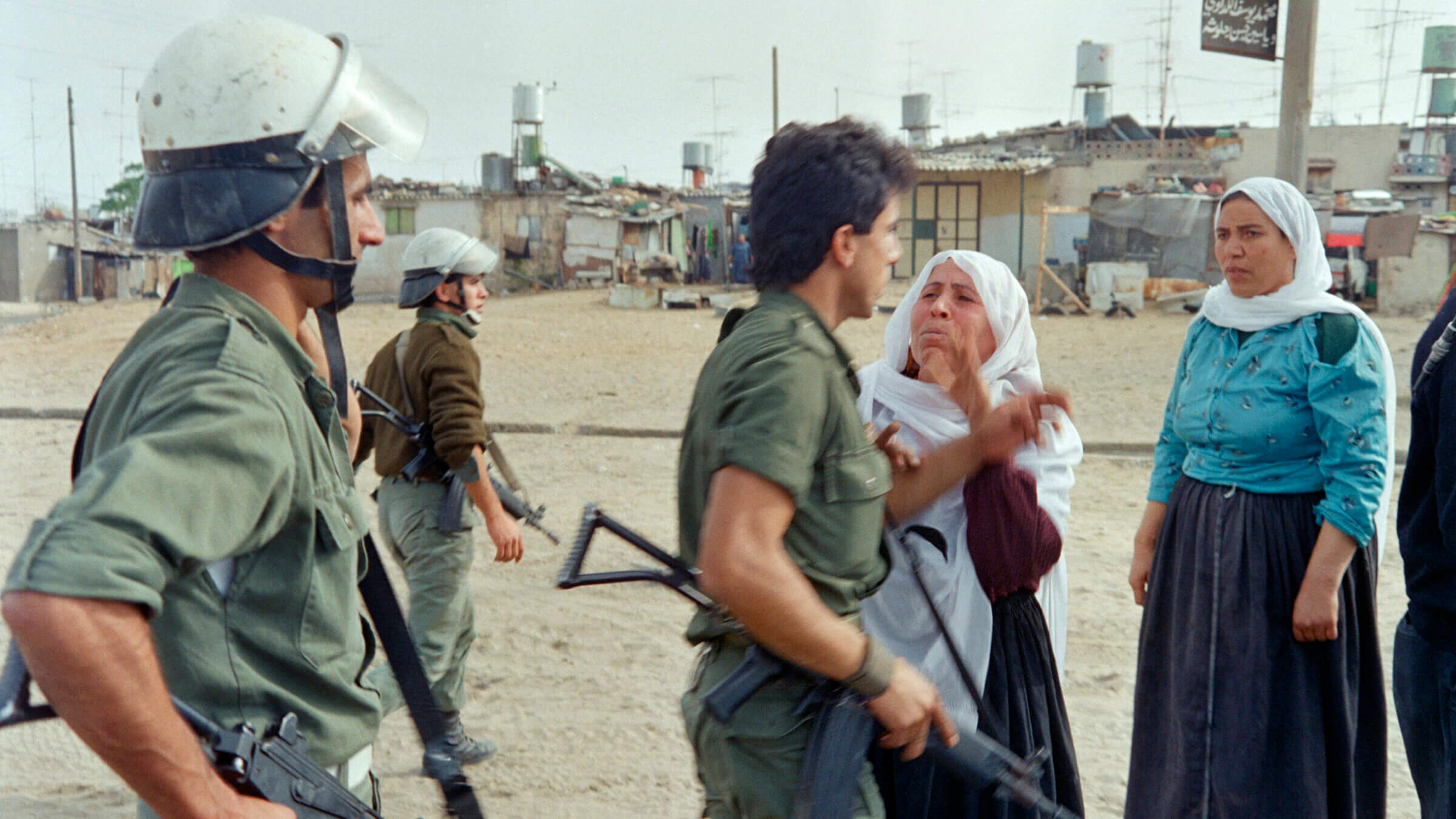 Israeli soldiers argue with Palestinian women in Jabalya refugee camp on December 09, 1987 after a curfew was imposed following violent demonstrations in the Gaza strip. The First Intifada, a Palestinian uprising against the Israeli occupation of the Palestinian Territories erupted in the Jabalia refugee camp and quickly spread throughout Gaza, the West Bank and East Jerusalem.