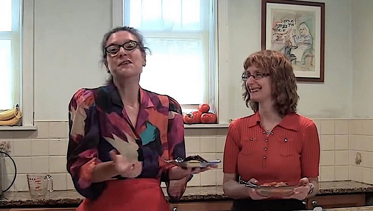 Eve Jochnowitz (left) and Rukhl Schaechter demonstrating how to make tzimmes, on their cooking show, "Est Gezunterheyt" ("Eat in Good Health")