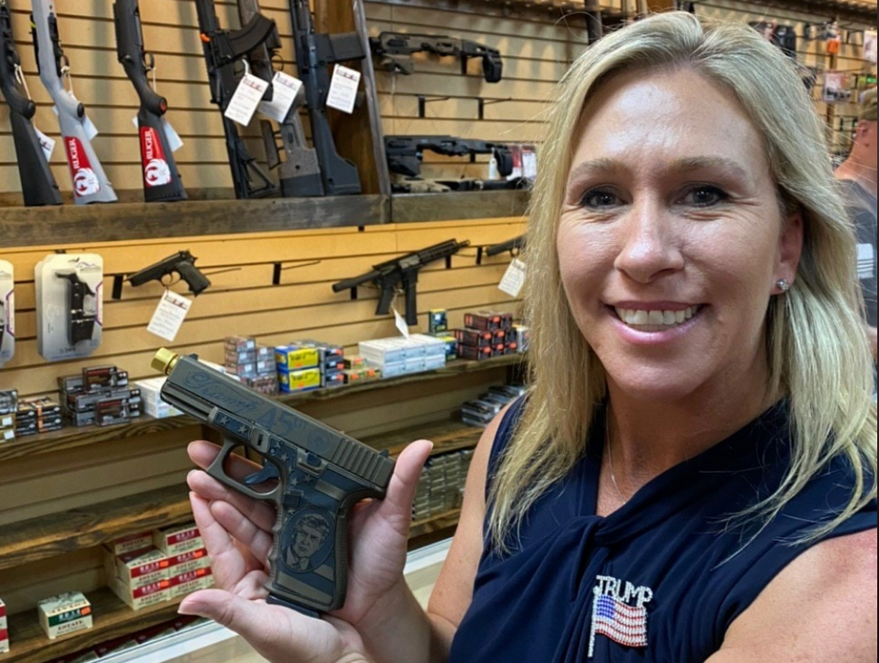 U.S. Rep. Marjorie Taylor Greene, Republican of Georgia, holds a gun. 