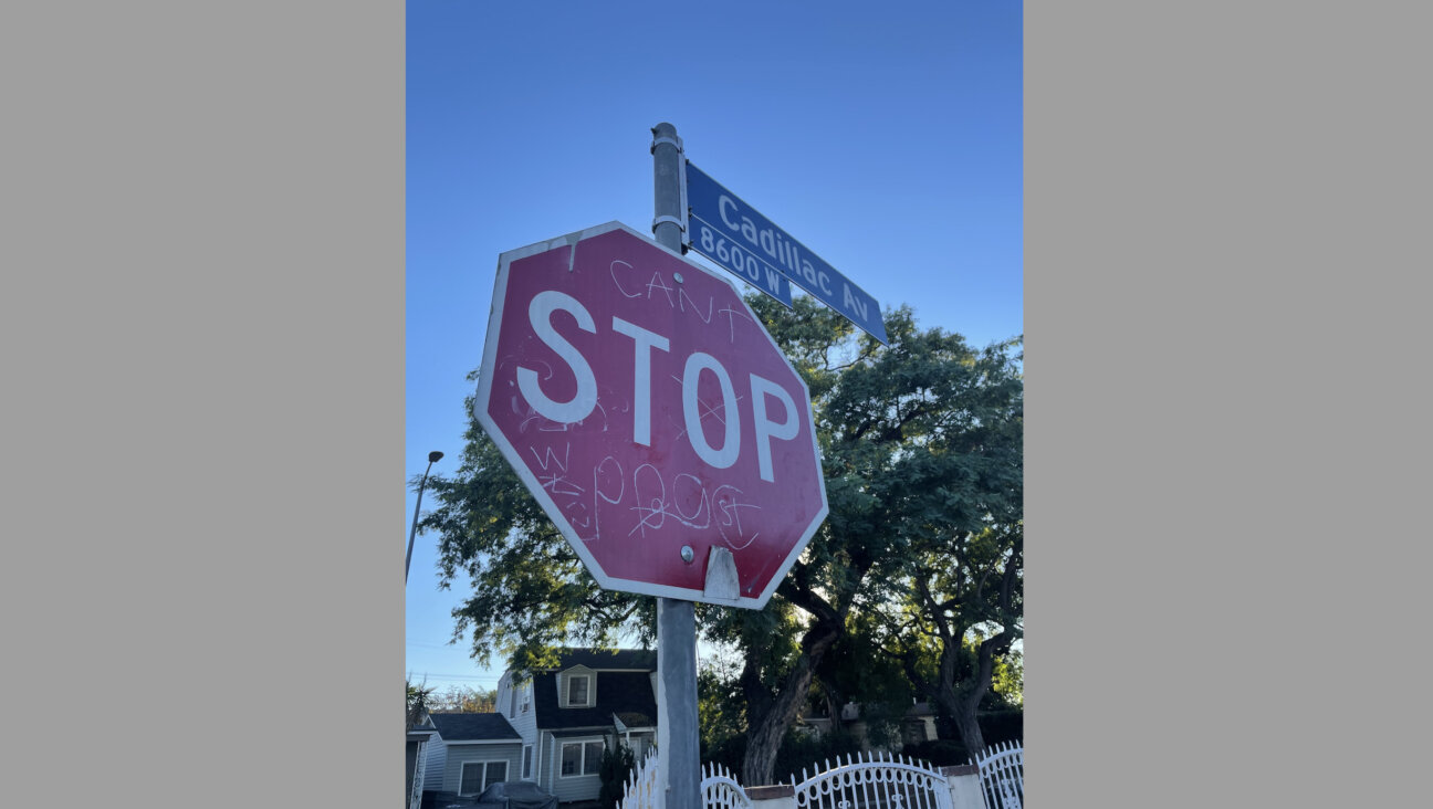A stop sign in the Cadillac-Corning neighborhood, tagged with Playboy Gangster Crips graffiti.