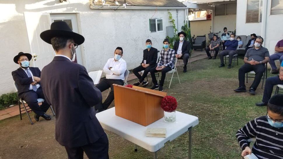 Nir Yacoby's backyard minyan observed mask and social distancing precautions.