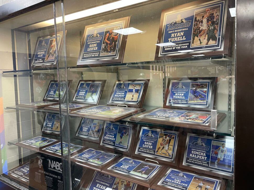 A display of Ryan Turell's Skyline Conference awards in the Yeshiva University gymnasium.