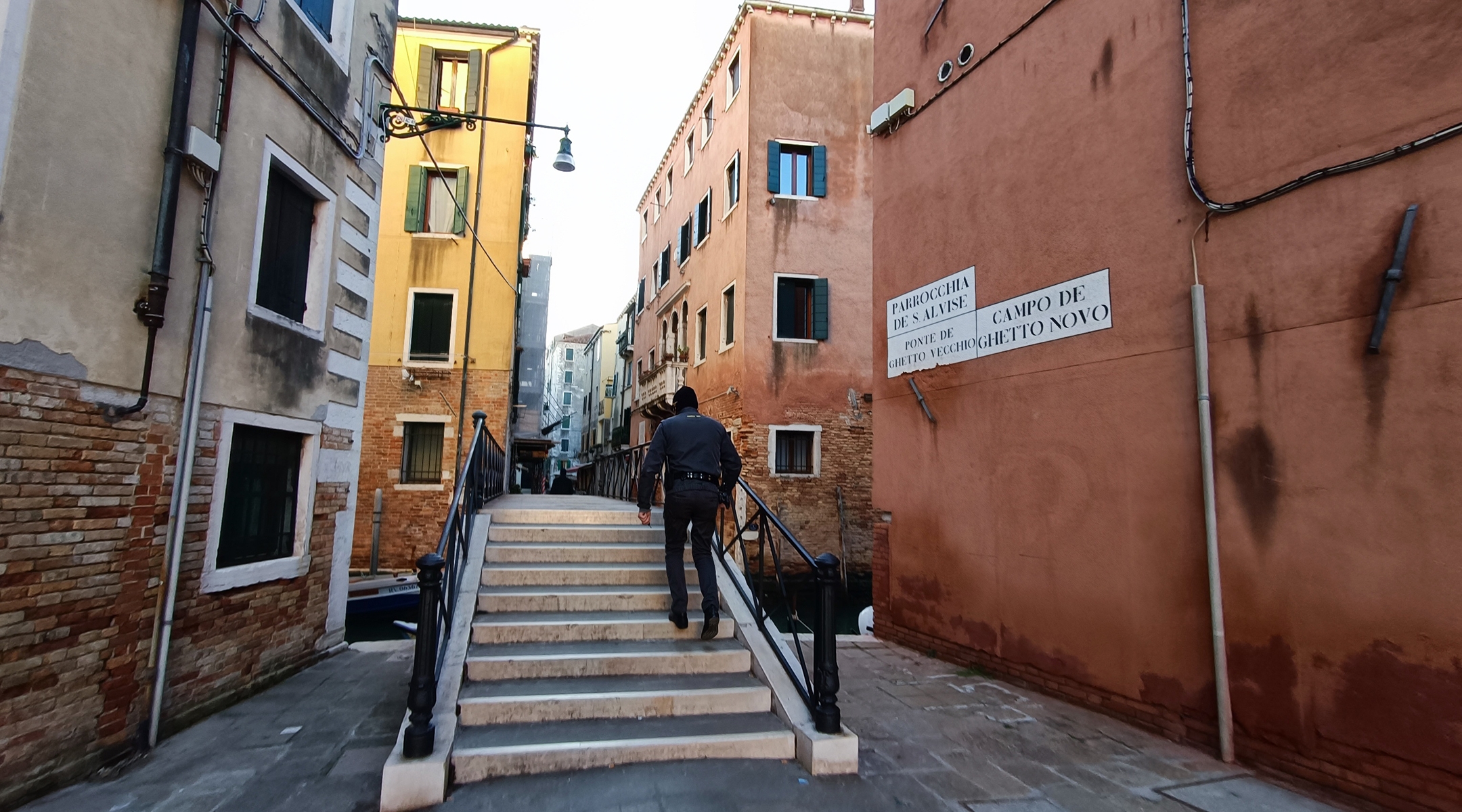 A guard climbs stairs by the entrance to the Campo di Ghetto Nuovo, or former Jewish Ghetto, in Venice. (Orge Castellano)