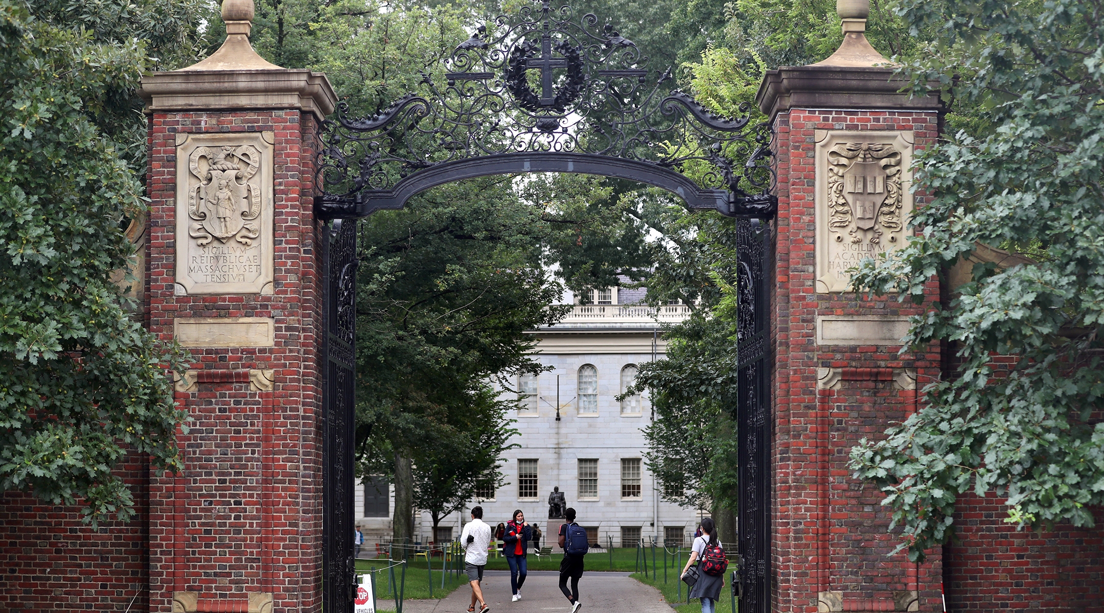 Students walk by the Harvard Yard gate in Cambridge, MA, Sep. 16, 2021. (David L. Ryan/The Boston Globe via Getty Images)