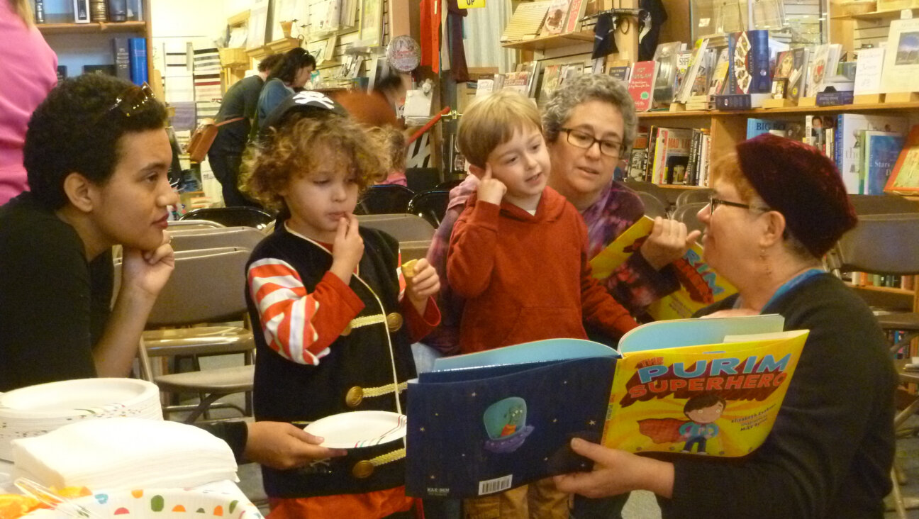 Author Elisabeth Kushner reads “The Purim Superhero” at a book-release party at Afikomen Judaica in Berkeley, California, in 2014. (Keshet)