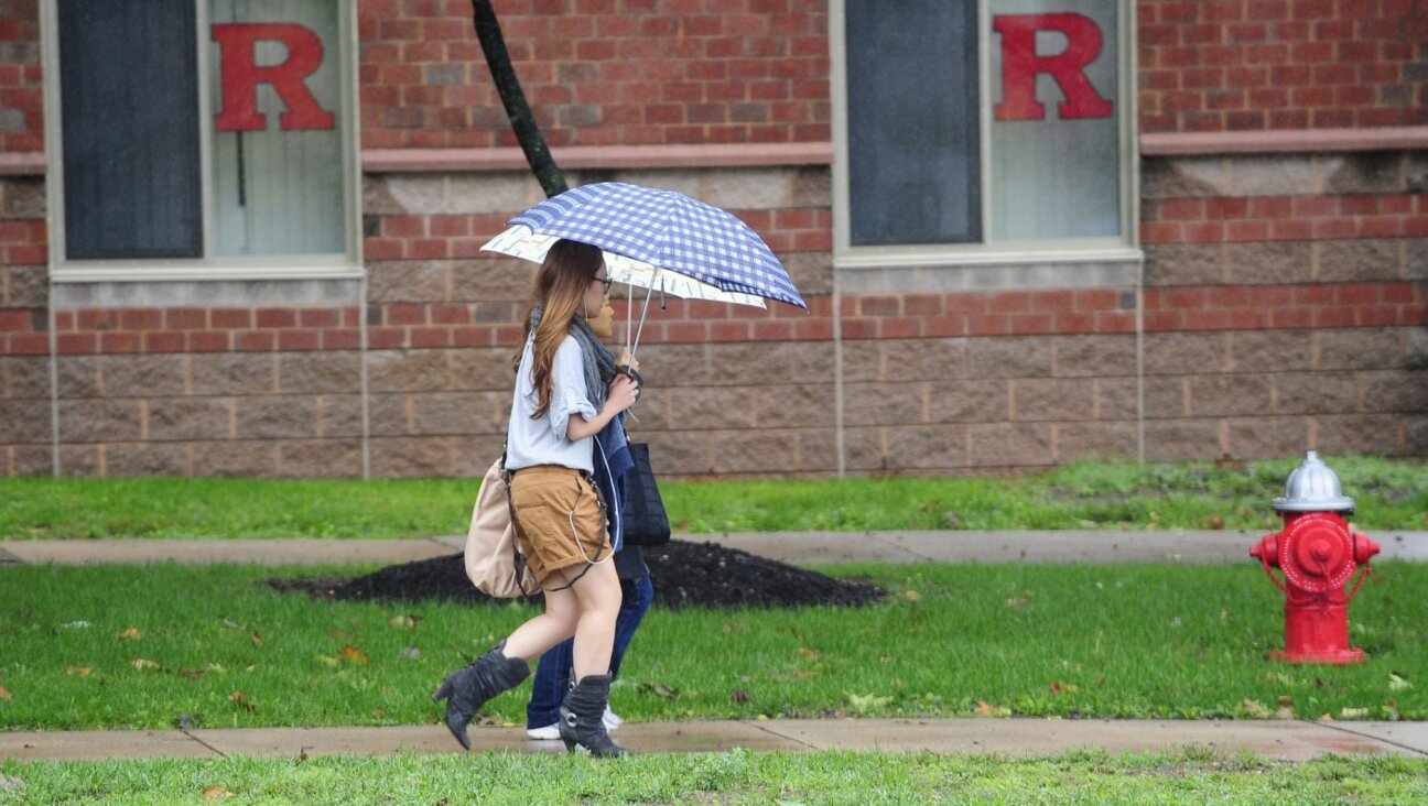 A student walks past the dormitory at Rutgers Univeristy in New Brunswick, New Jersey on October 1, 2010.
