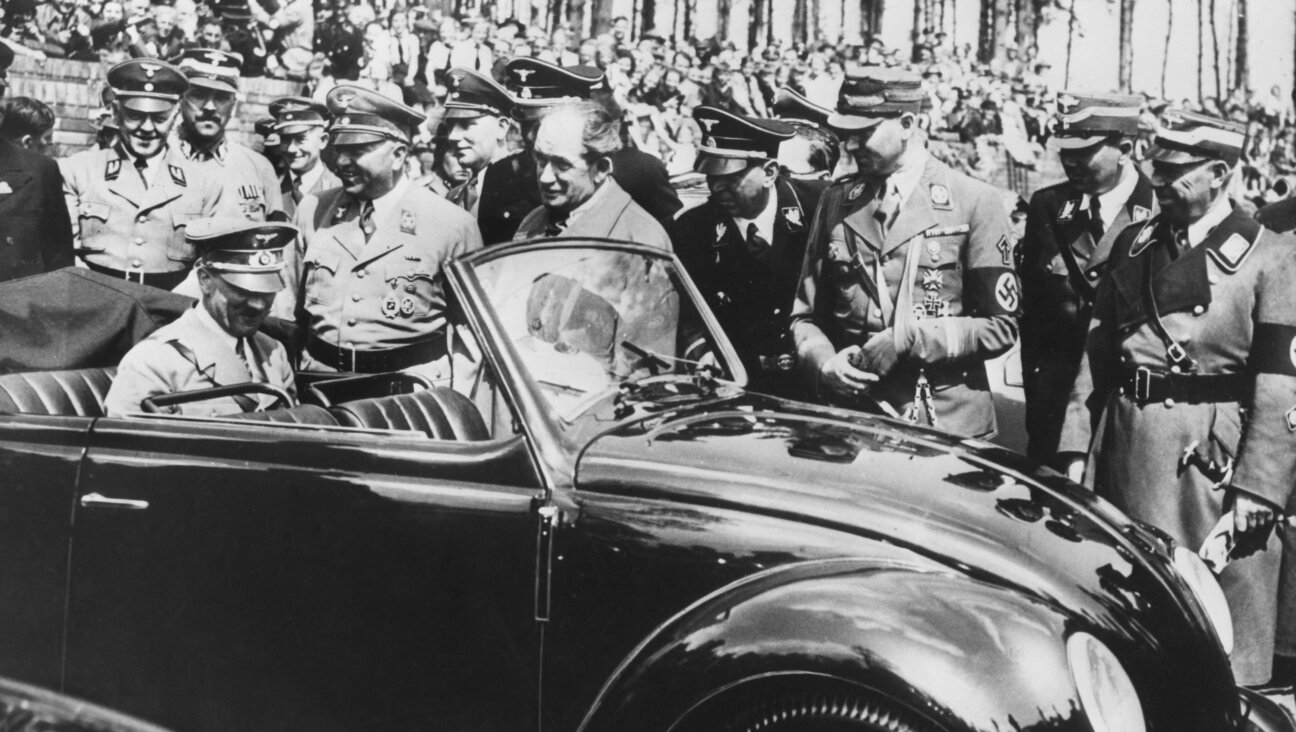 Adolf Hitler (seated in back) inspects the first Volkswagen "Beetle" produced in Stuttgart in 1937. 