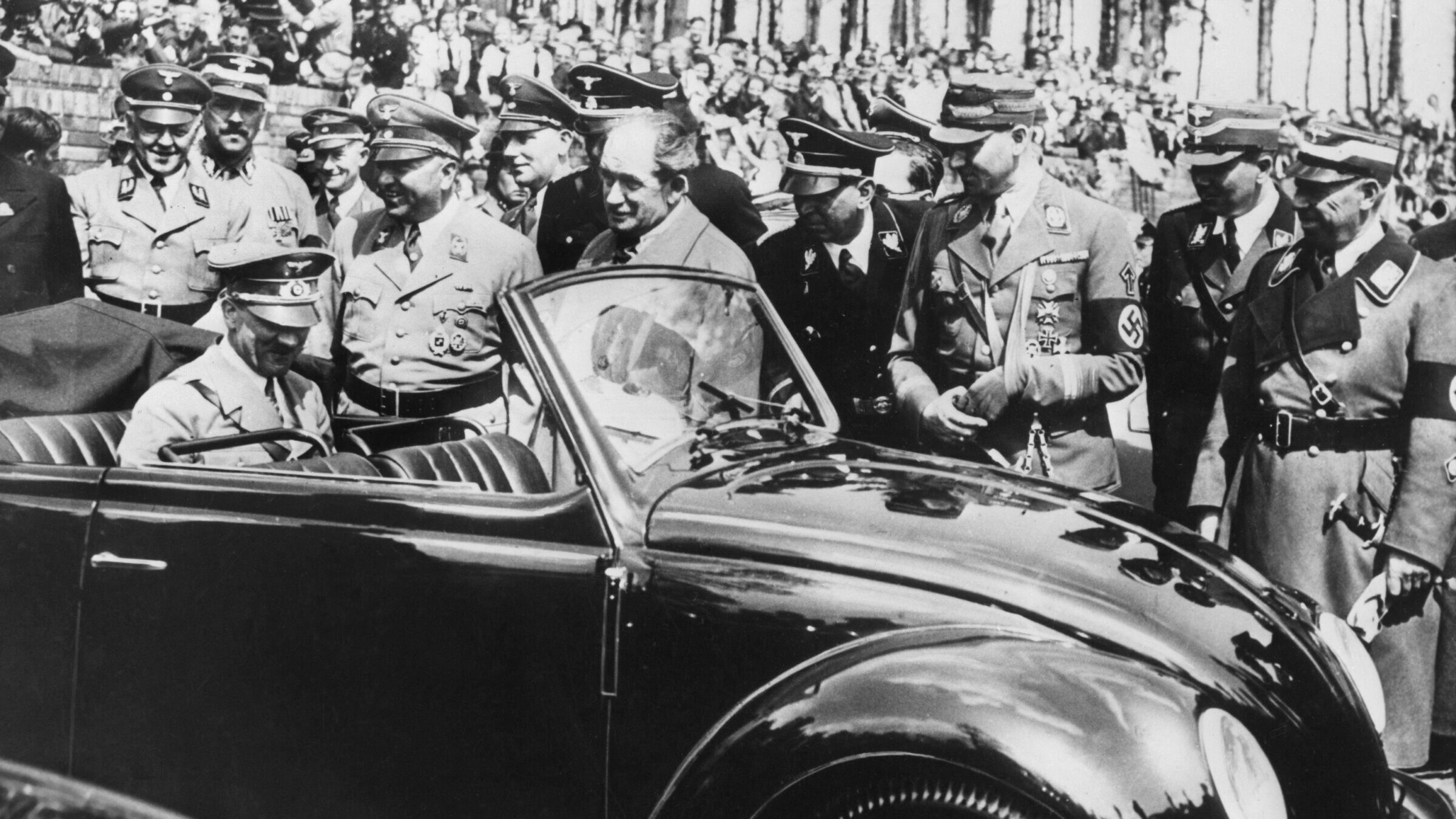 Adolf Hitler (seated in back) inspects the first Volkswagen "Beetle" produced in Stuttgart in 1937. 