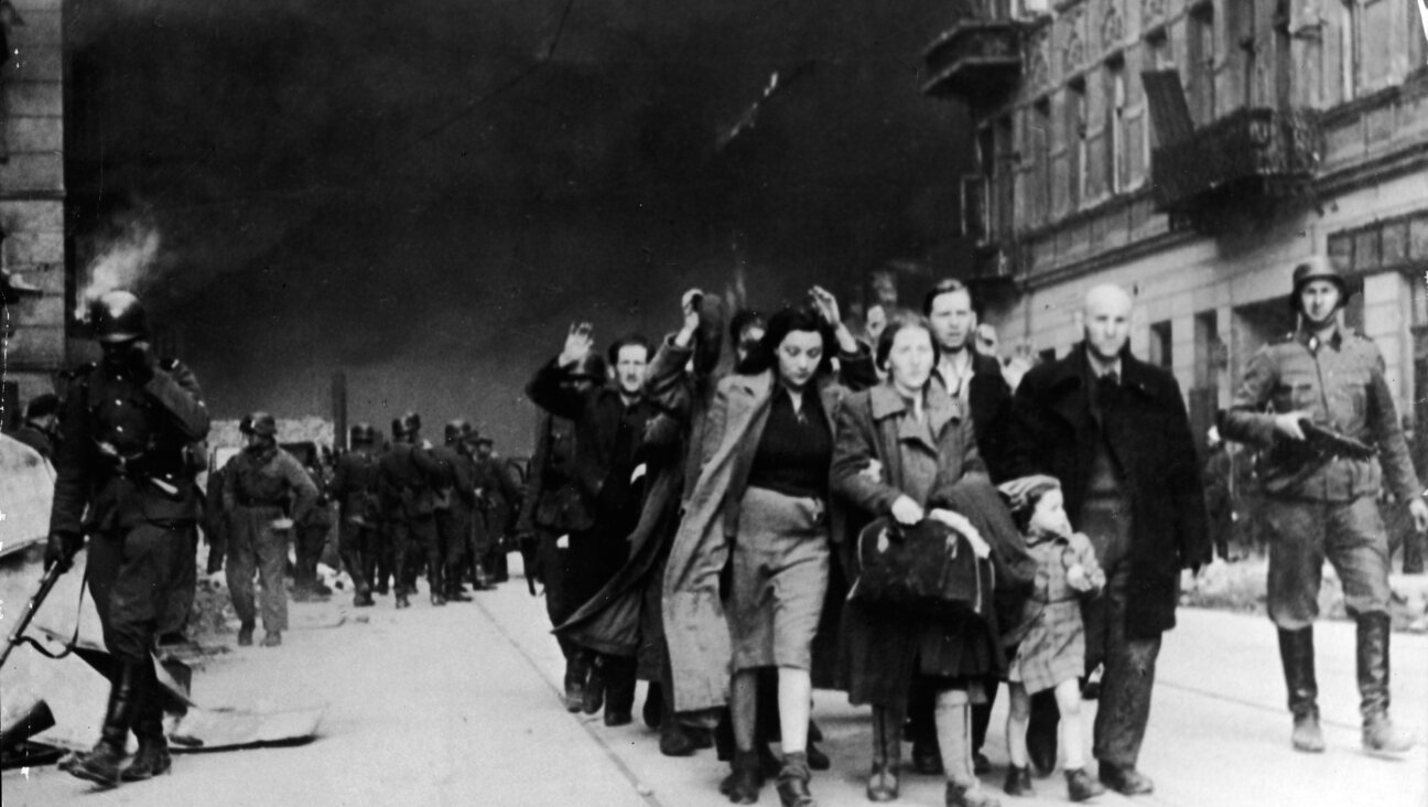 Captured Jewish civilians who participated in the Warsaw Ghetto Uprising are marched out of the city by Nazi troops, Warsaw, Poland, April 19, 1943. 