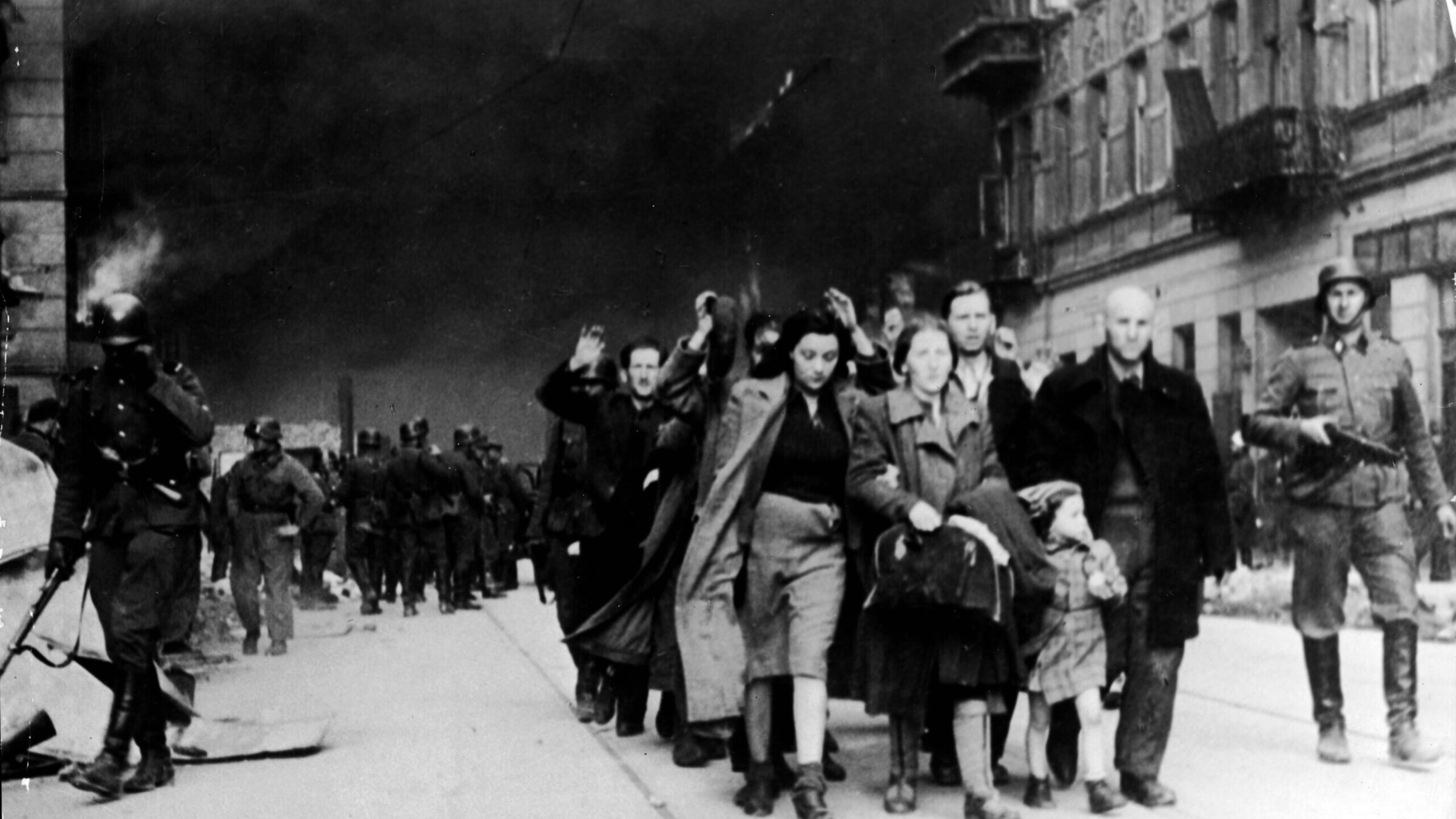 Captured Jewish civilians who participated in the Warsaw Ghetto Uprising are marched out of the city by Nazi troops, Warsaw, Poland, April 19, 1943. 
