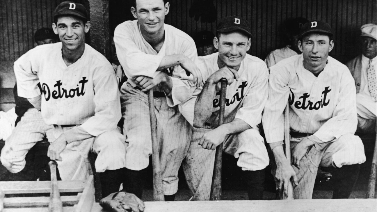 Four members of the Detroit Tigers baseball team pose in the dugout on July 5, 1932. From left, Ukrainian-born Izzy Goldstein (1908 - 1993) and Americans Harry Davis (1908 - 1997), Gee Walker (1908 - 1981), and Heinie Schuble (1906 - 1990)