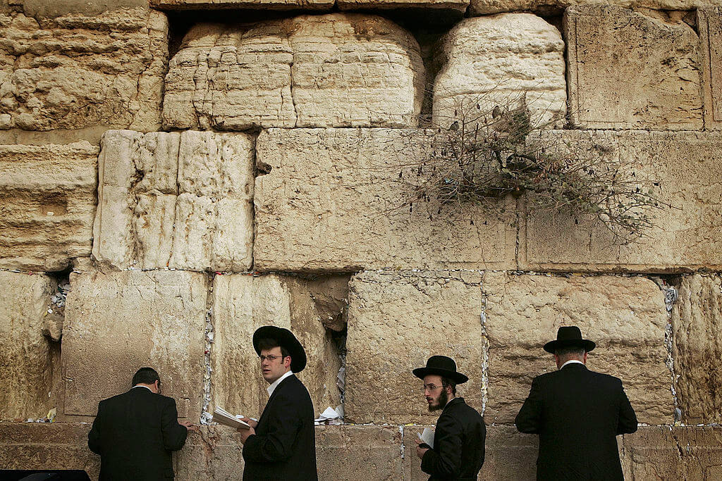 Jewish men pray at the Western Wall.