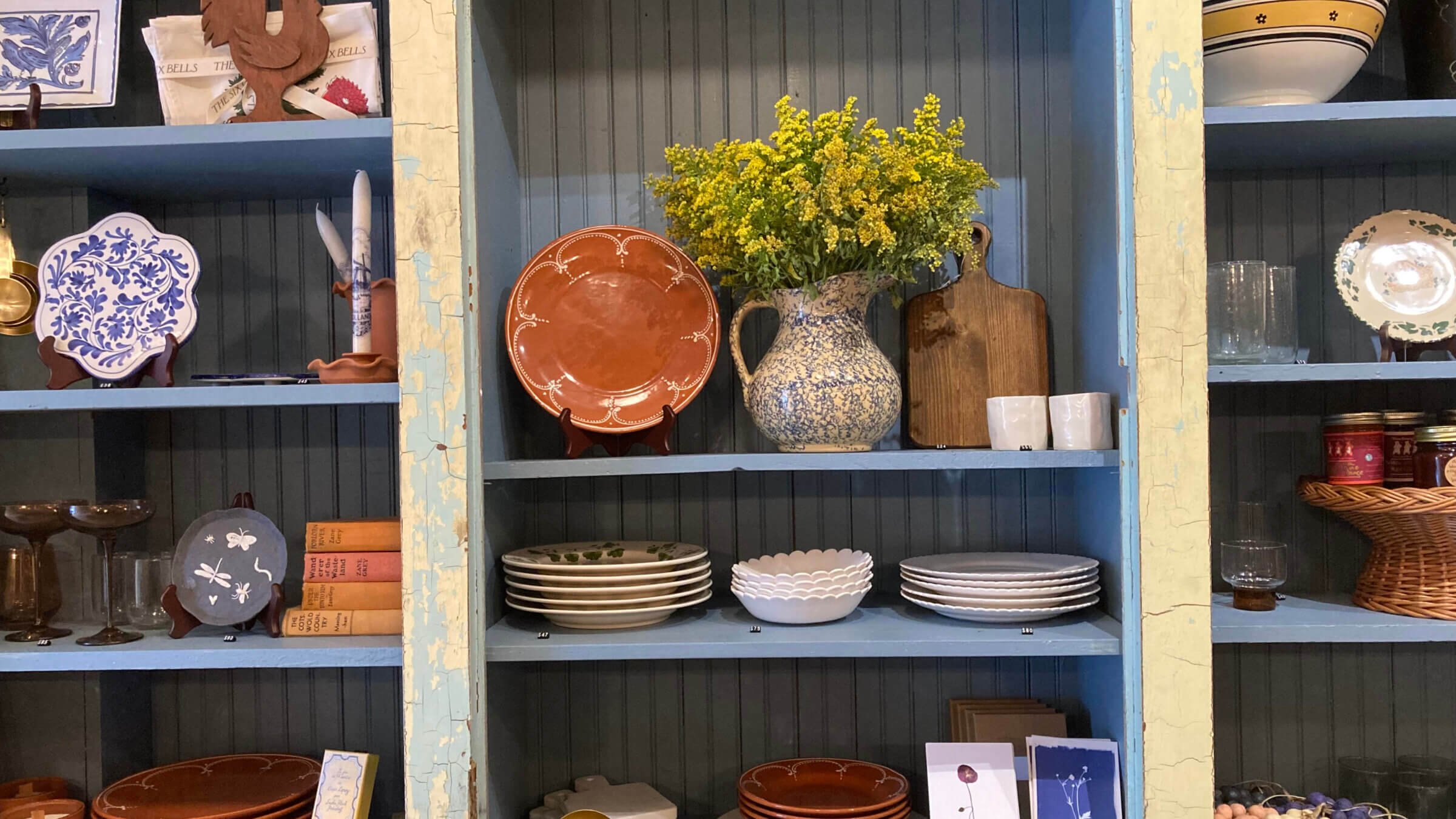 Carefully weathered shelves house rustic-chic dinnerware at The Six Bells.