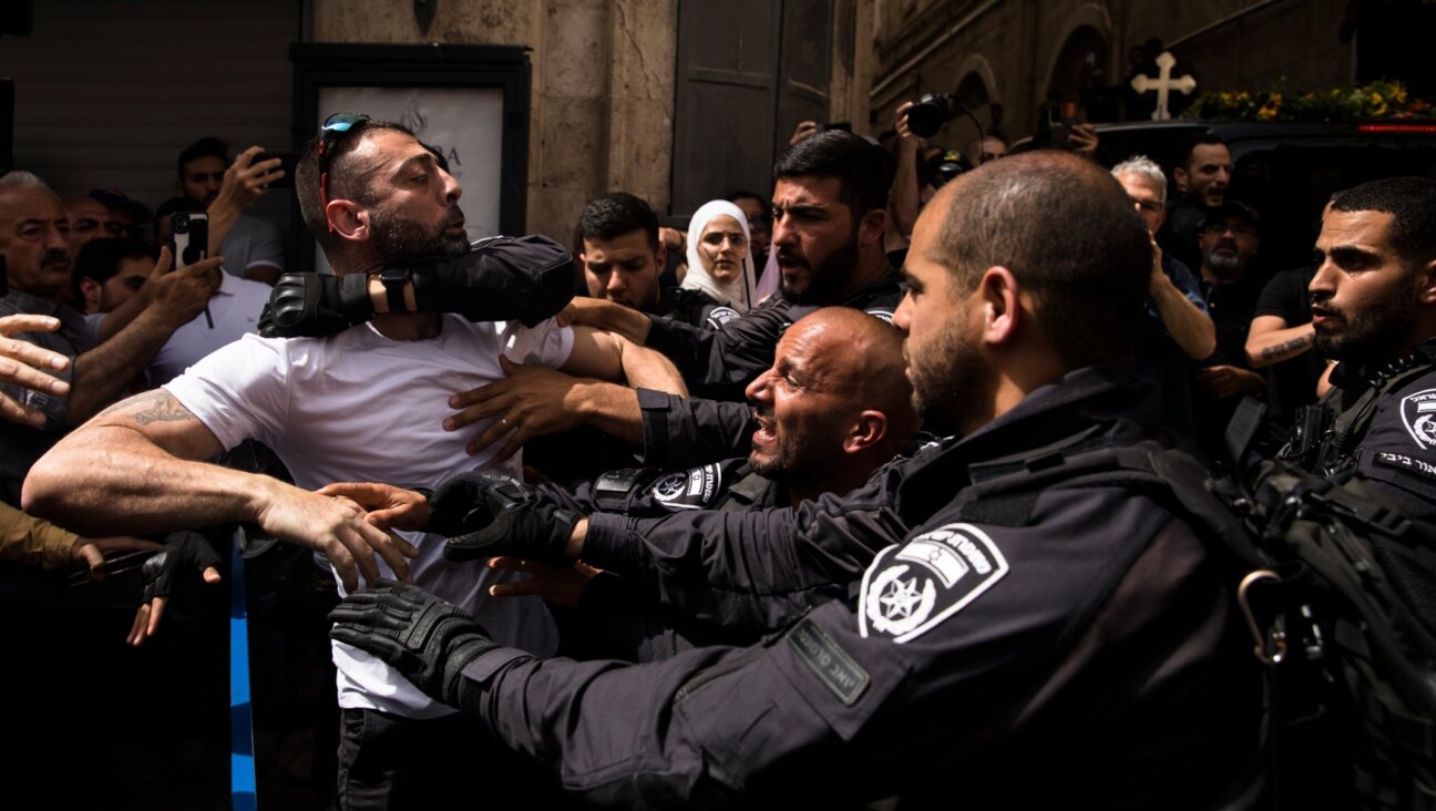 Police officers clash with attendees of the funeral of Al Jazeera reporter Shireen Abu Akleh in Jerusalem, May 12, 2022. 