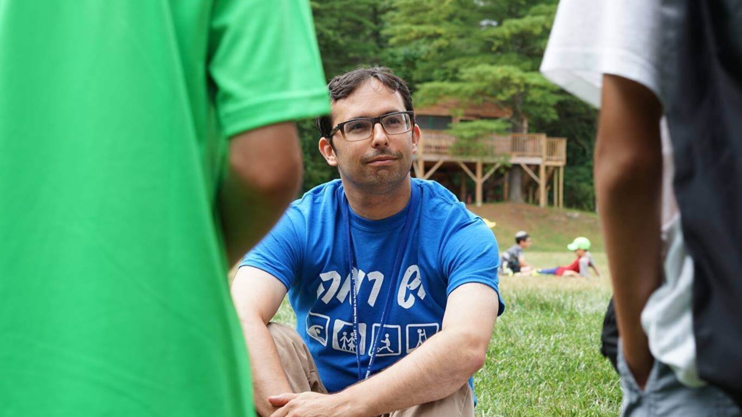 Rabbi Ethan Linden, director of Camp Ramah of the Berkshires, sits facing two campers.
