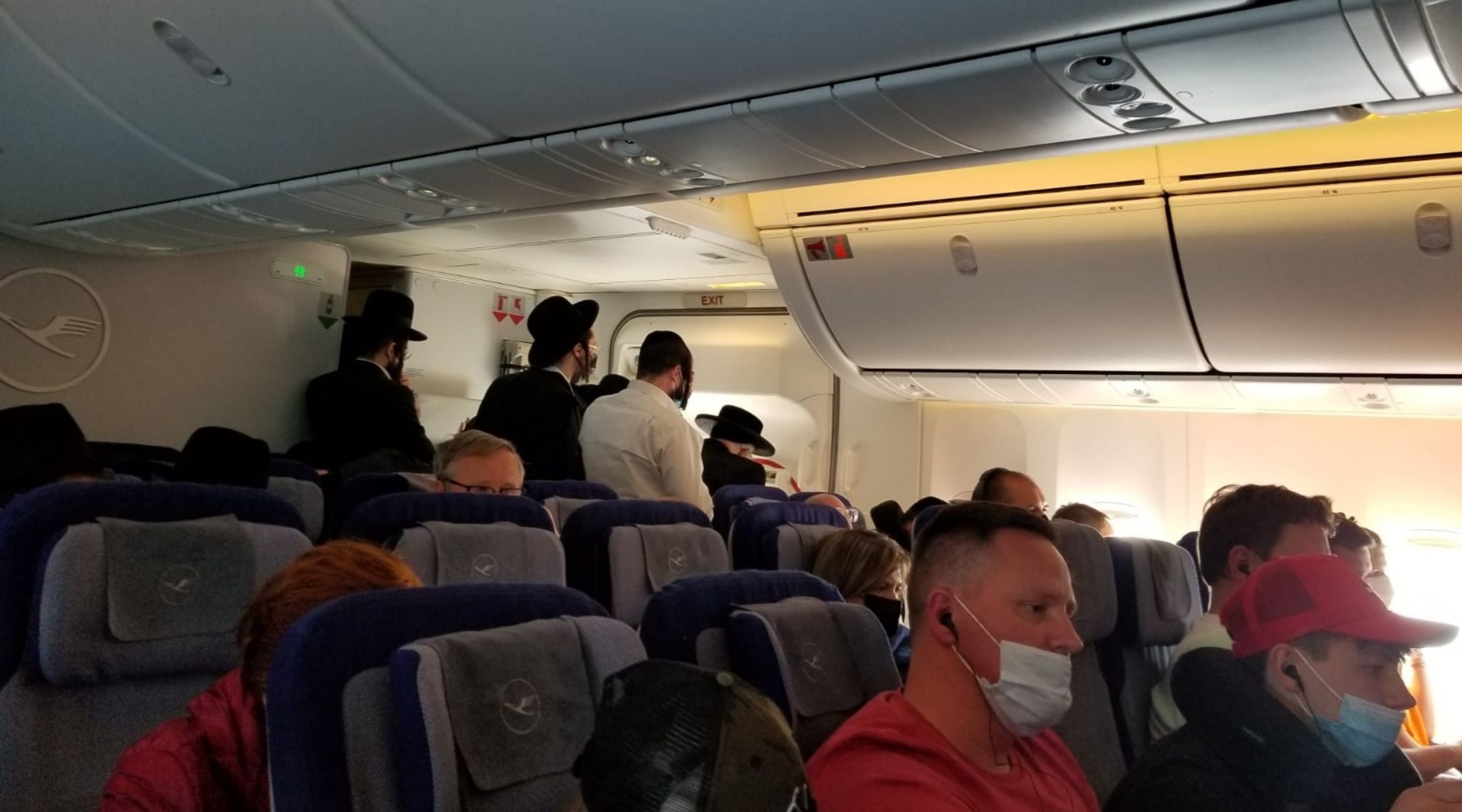 Inside the Lufthansa flight to Frankfurt, Orthodox Jewish men pray in the back of the plane. (Courtesy)