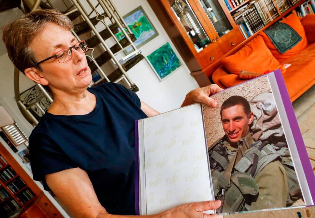 Leah Goldin, the mother of Israeli soldier Lieutenant Hadar Goldin, holds  a picture of her son in the central Israeli city of Kfar Saba on August 29, 2018. 