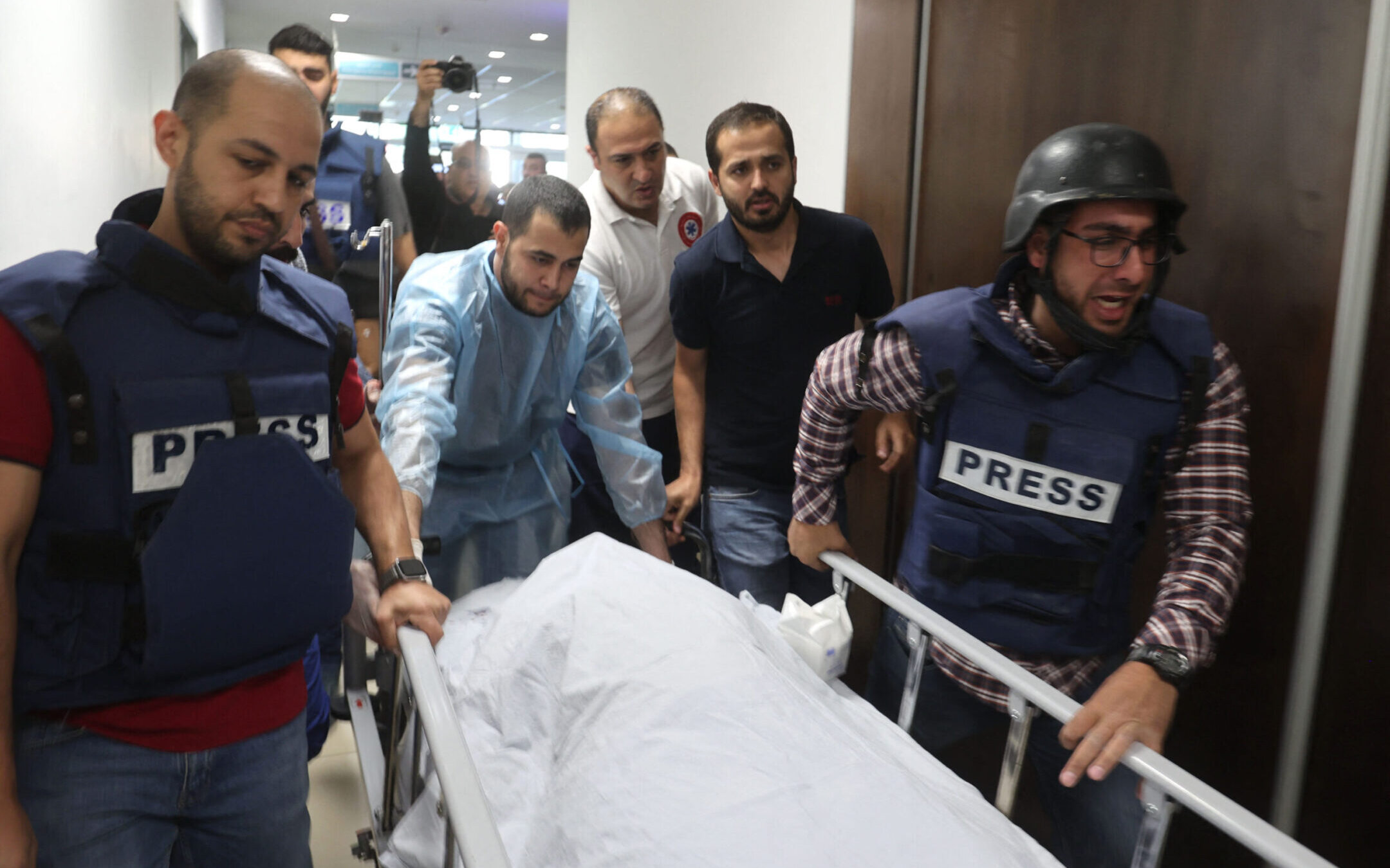 Mujahed al-Saadi, a cameraman for Palestine Today TV, escorts the body of veteran Al-Jazeera reporter Shireen Abu Akleh, who was shot and killed as she covered a raid on the West Bank’s Jenin refugee camp, May 11, 2022, at the hospital in Jenin.(Jaafar Ashtiyeh/AFP via Getty Images)