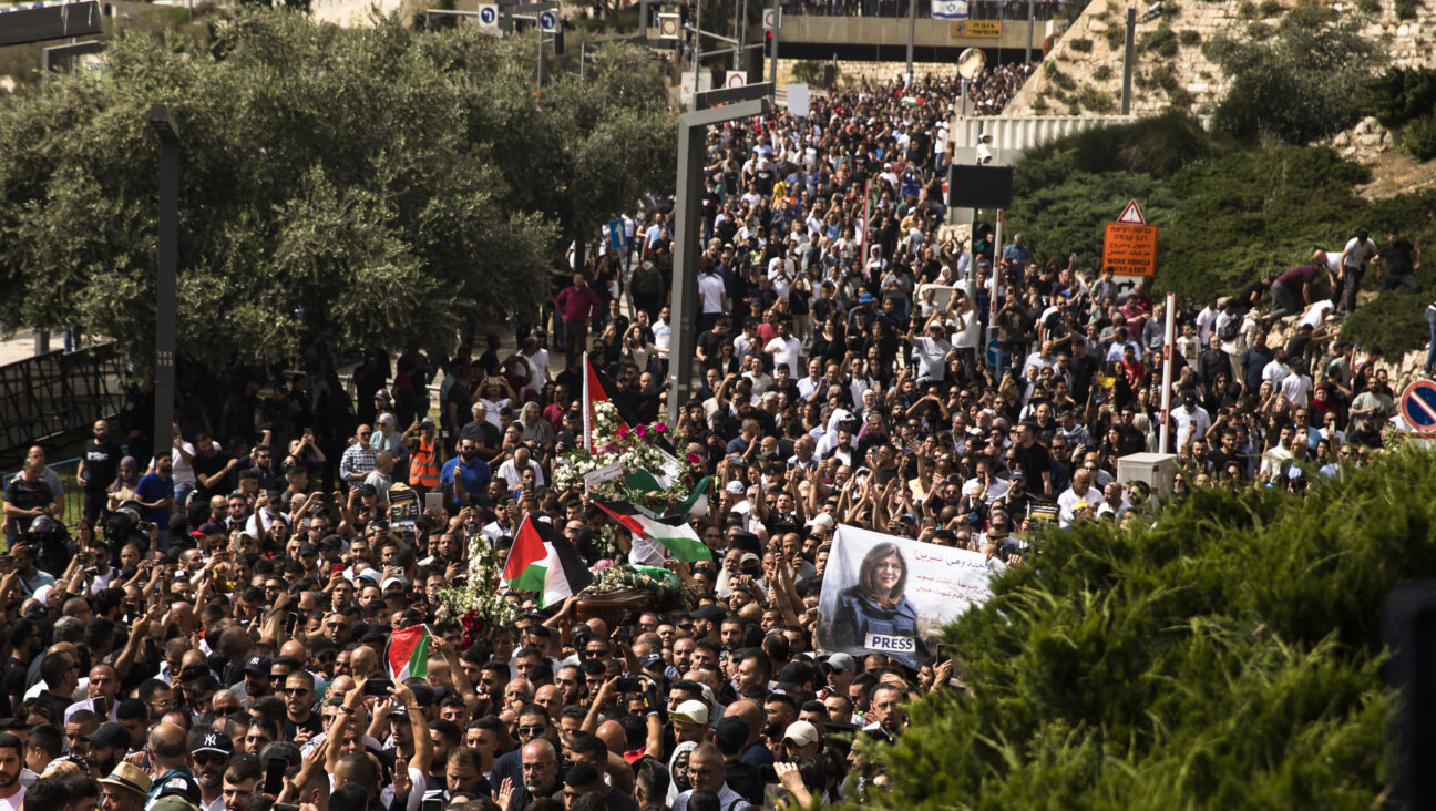 Police officers clash with attendees of the funeral of Al Jazeera reporter Shireen Abu Akleh in Jerusalem.