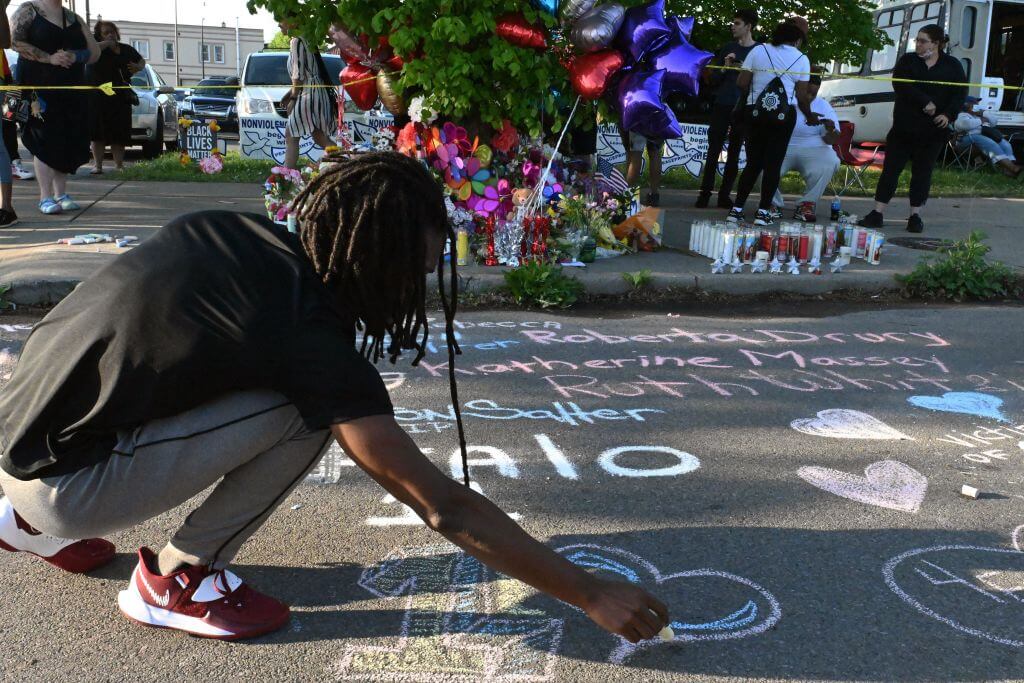 People leave messages at a makeshift memorial near a Tops Grocery store in Buffalo, New York, on May 15, 2022, the day after a gunman shot dead 10 people. 