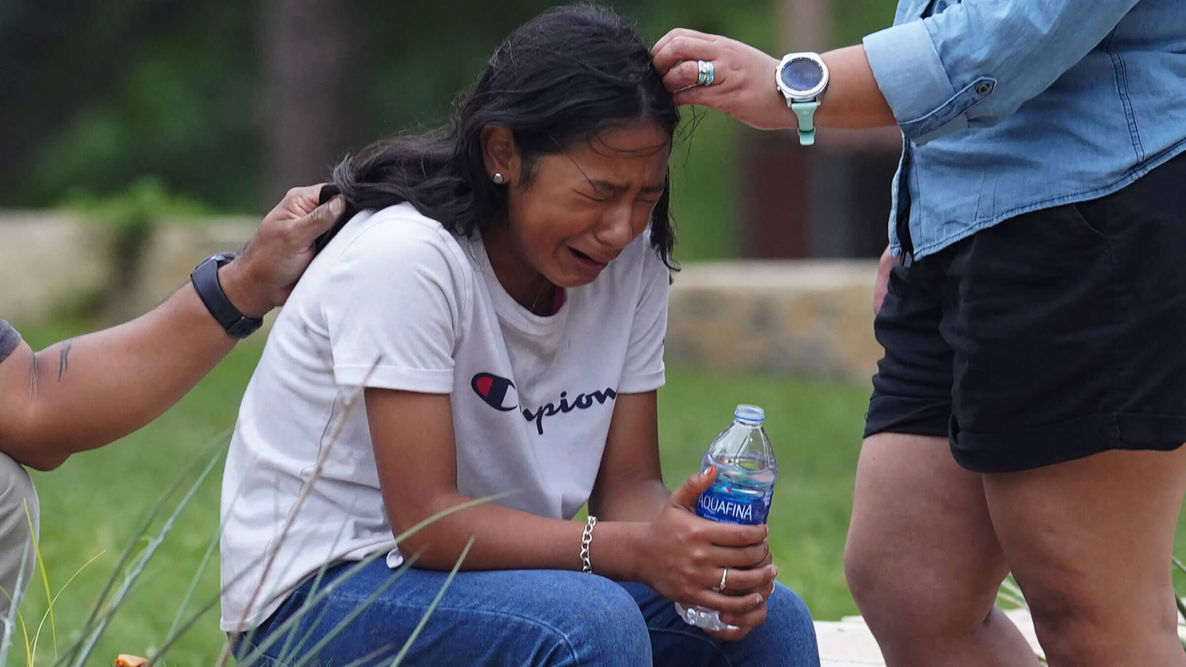 A girl cries outside a civic center where grief counseling is offered in Uvalde, Texas.
