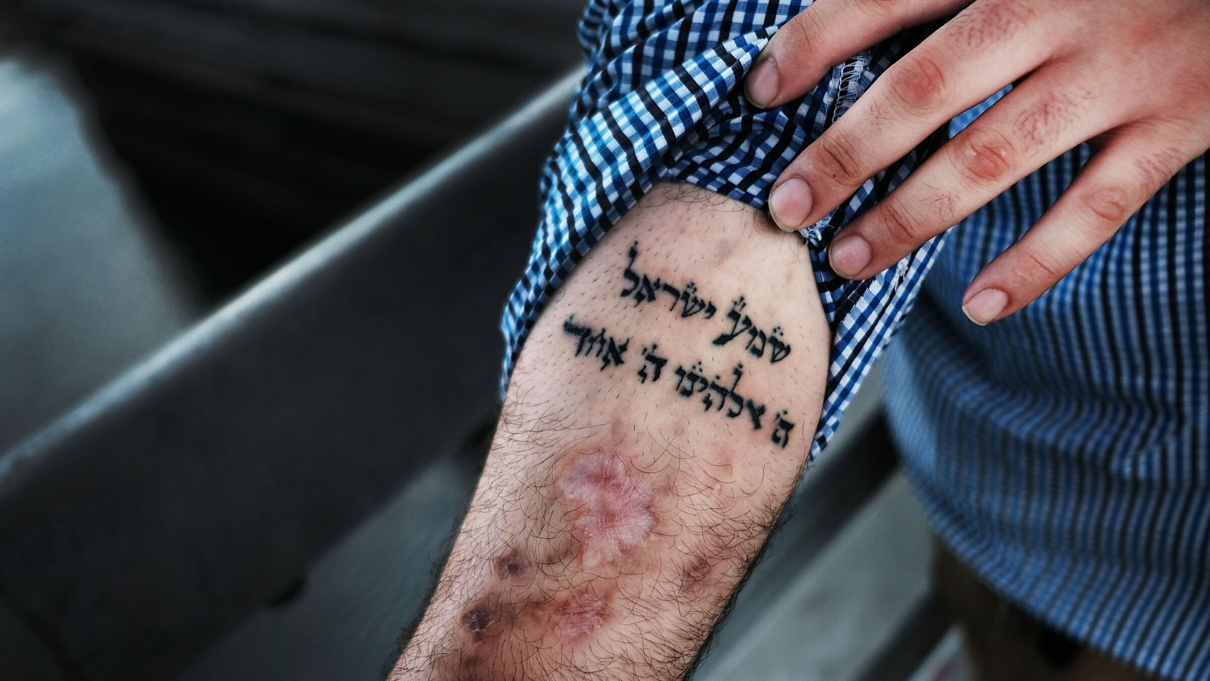 Michael, a patient at a Brooklyn methadone clinic for those addicted to heroin, displays a Hebrew tattoo of the "shema" prayer that he looks to in his fight with addiction.