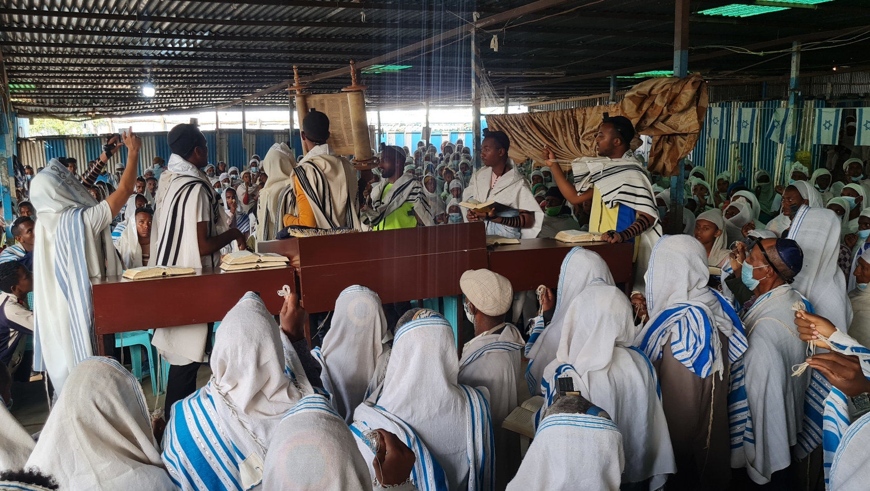 Members of the Falash Mura community celebrate with a festive prayer service the immigration to Israel of 180 people from Gondar, Ethiopia, May 31, 2022. (Cnaan Liphshiz)