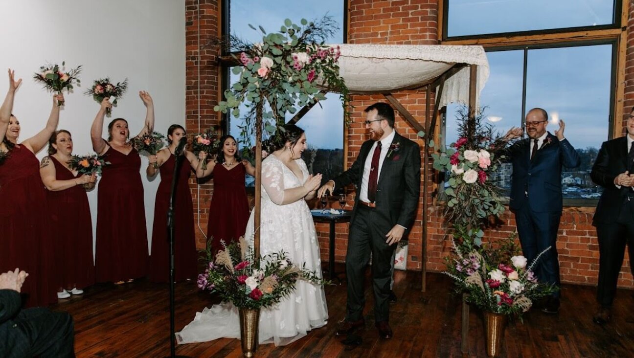 The wedding of Molly Kazin, who is Jewish, and Evan Marshall, who is not, in Holyoke, Massachusetts, on November 20, 2021. Though Kazin grew up in a Conservative congregation, she assumed she could not get a rabbi in the movement to preside at her wedding, and found one through the group where she works, 18Doors, which supports relationships between Jews and non-Jews.