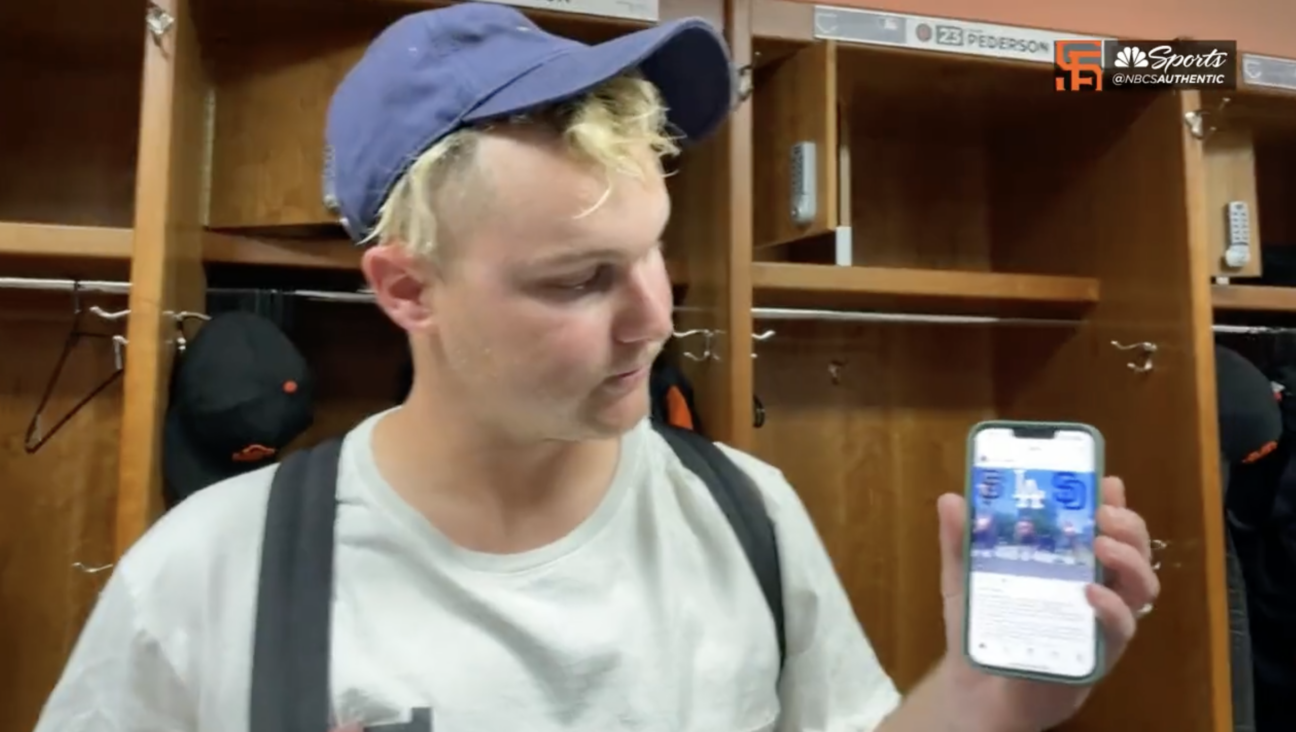 Joc Pederson shows reporters the GIF he sent to a fantasy football group chat, which incensed Tommy Pham.