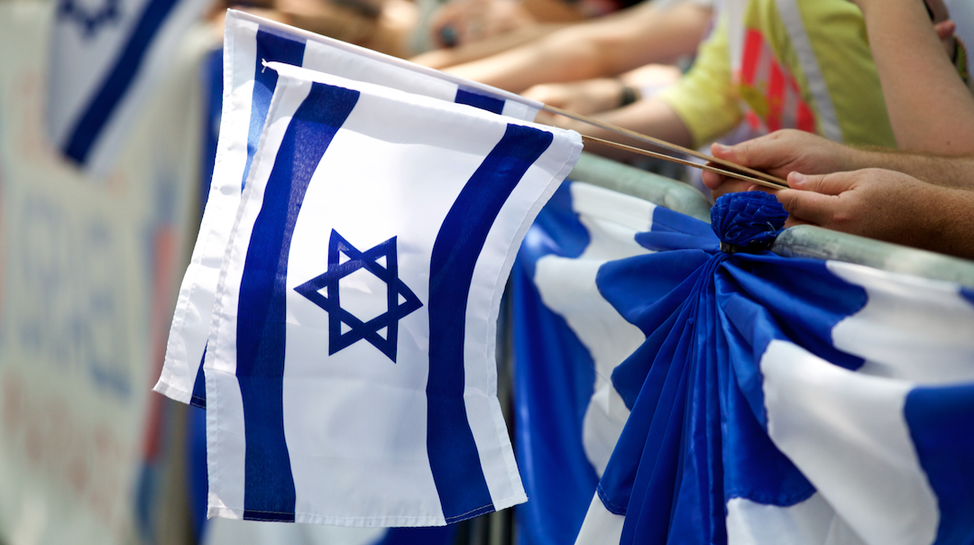Marchers carry Israeli flags during the Celebrate Israel Parade, June 2, 2019. (Courtesy JCRC-NY)