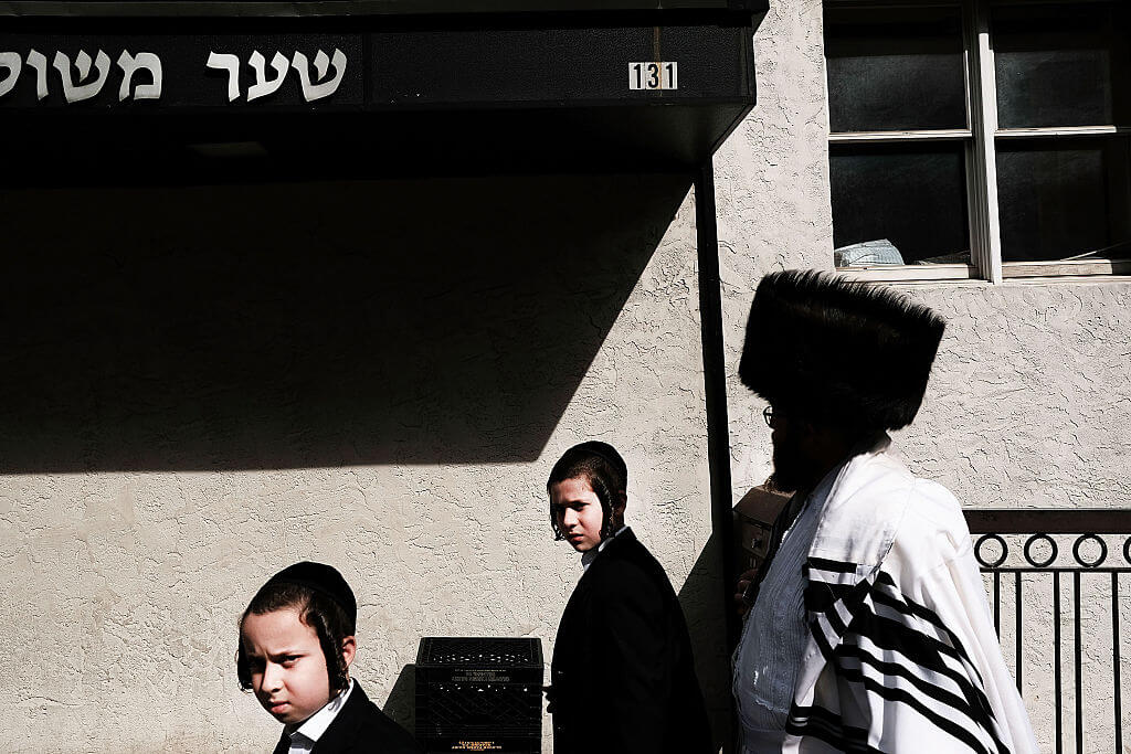 Members of an Orthodox Jewish community in Williamsburg, Brooklyn walk through the neighborhood on Yom Kippur, one of the most important holidays of the Jewish year on October 12, 2016 in New York City. 