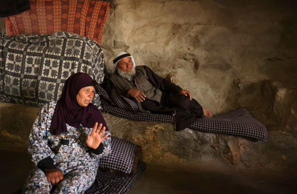 Ali Mohammed Jabbareen, right, sits at his family house in the Palestinian village of Jinba, part of the Masafer Yatta area in the Israeli-occupied West Bank, on May 9, 2022, following an Israeli High Court decision that approved the eviction of roughly 1,000 Palestinian villagers to make way for a military training zone. 