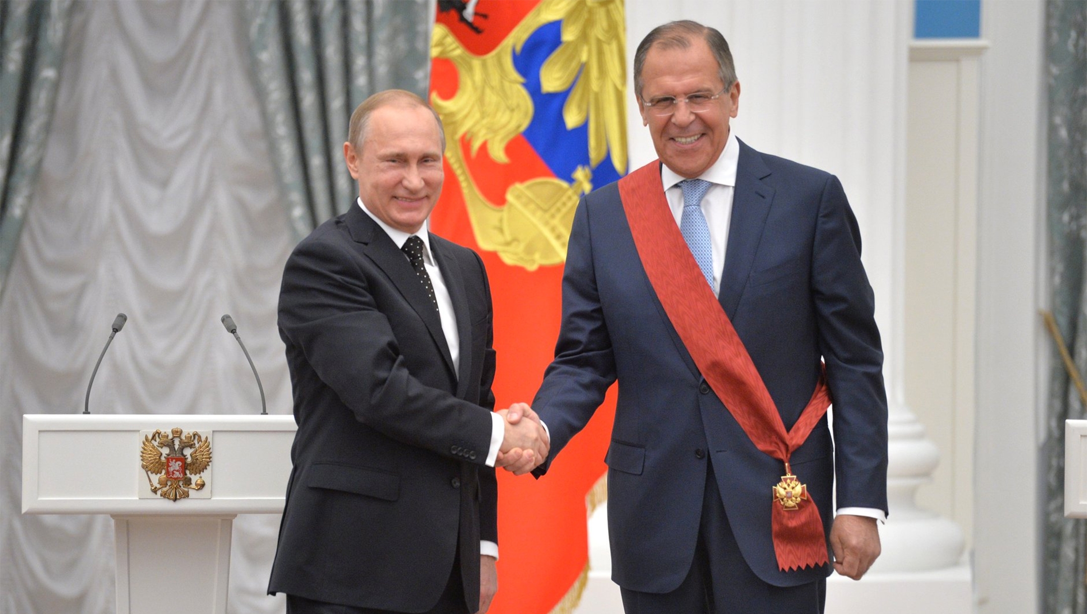 Russian Foreign Minister Sergei Lavrov, right, shakes hands with President Vladimir Putin in Moscow, May 21, 2015. (Kremlin media center)