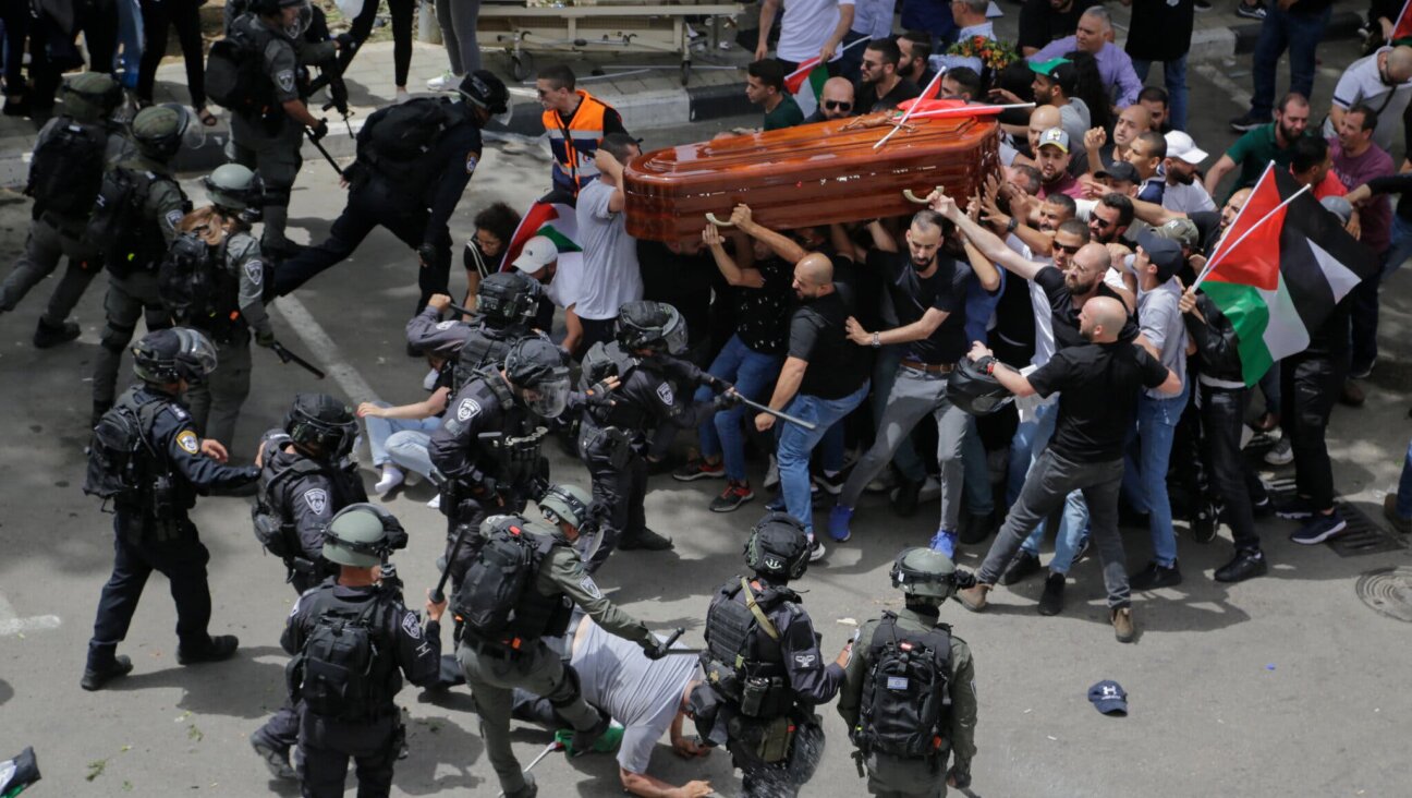 Israeli police officers attacking mourners carrying the coffin of Shireen Abu Akleh on  May 13, 2022.  