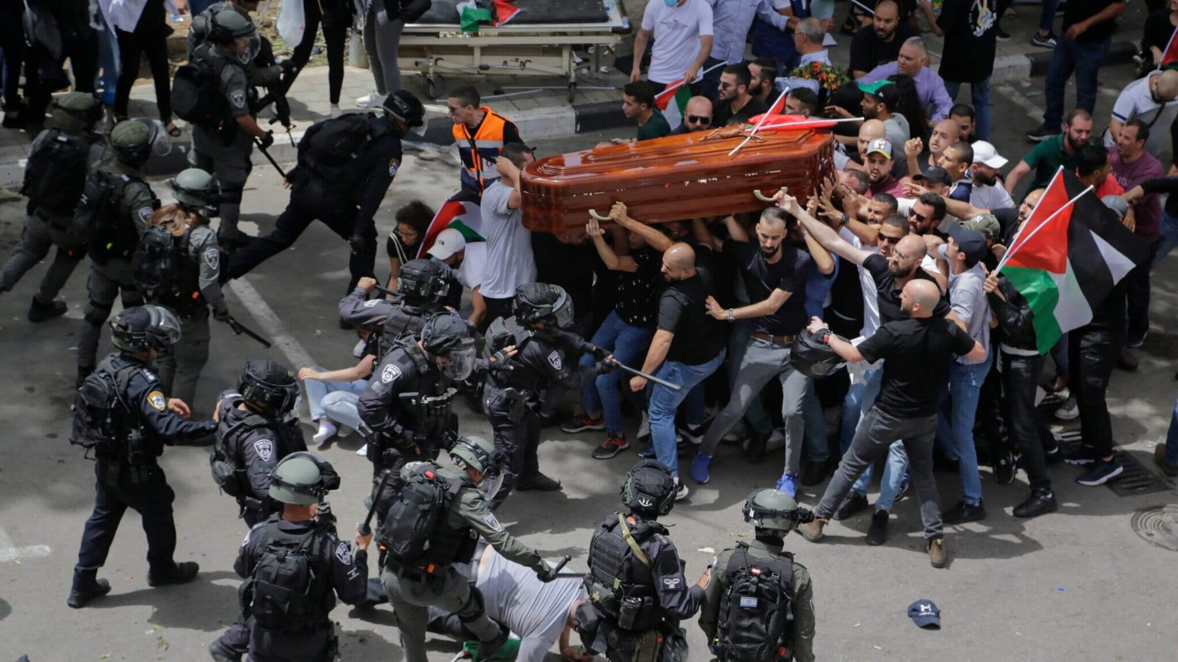 Israeli police officers attacking mourners carrying the coffin of Shireen Abu Akleh on  May 13, 2022.  