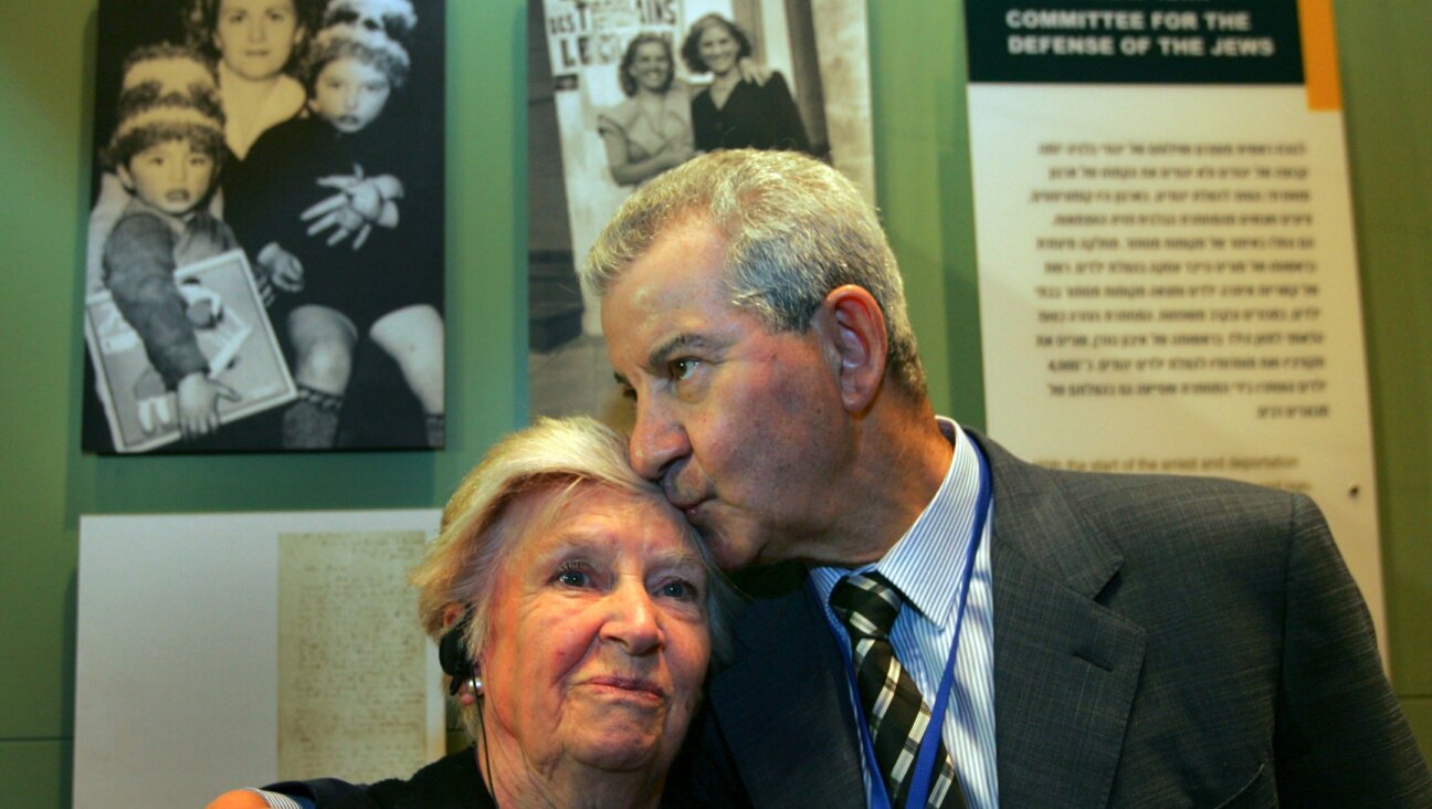 Andrée Geulen-Herscovici, a Belgian woman who rescued some 300 Jewish children from the Nazis during the Holocaust, is embraced by Henri Lederhandler, one of the children she rescued, in front of the exhibit on her efforts in the museum of the Yad Vashem Holocaust Memorial in Jerusalem, April 18, 2007. (David Silverman/Getty Images)