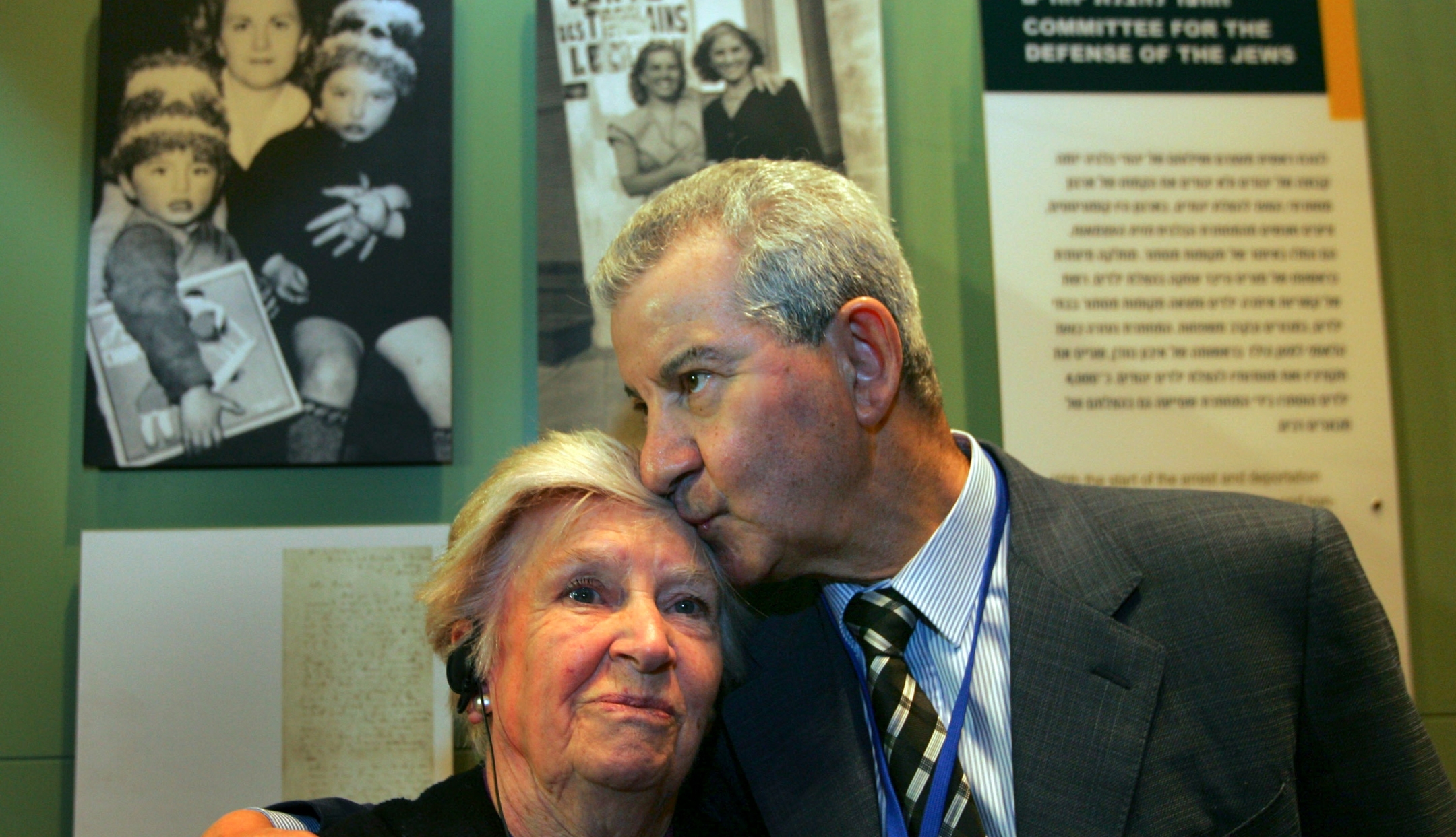 Andrée Geulen-Herscovici, a Belgian woman who rescued some 300 Jewish children from the Nazis during the Holocaust, is embraced by Henri Lederhandler, one of the children she rescued, in front of the exhibit on her efforts in the museum of the Yad Vashem Holocaust Memorial in Jerusalem, April 18, 2007. (David Silverman/Getty Images)