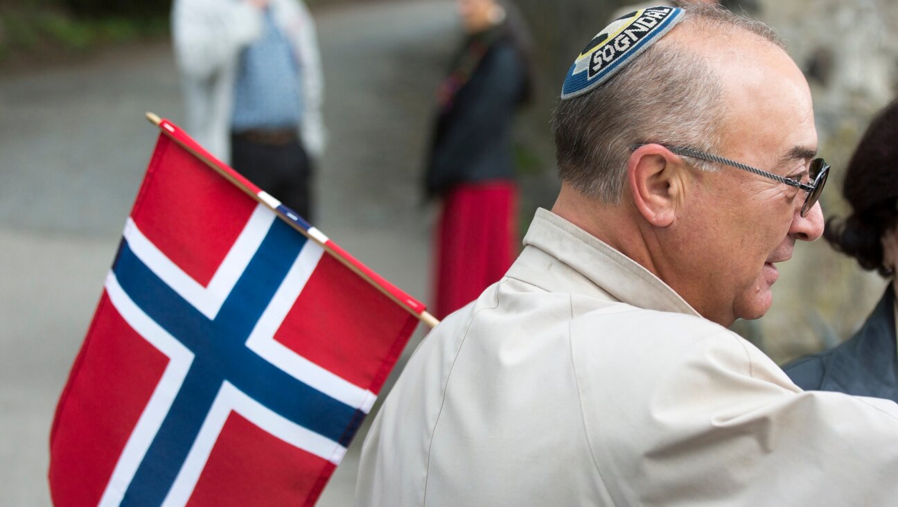 A Jewish man wearing a kippah holds a Norwegian flag on Constitution Day in Oslo. (Fishman/ullstein bild via Getty Images)