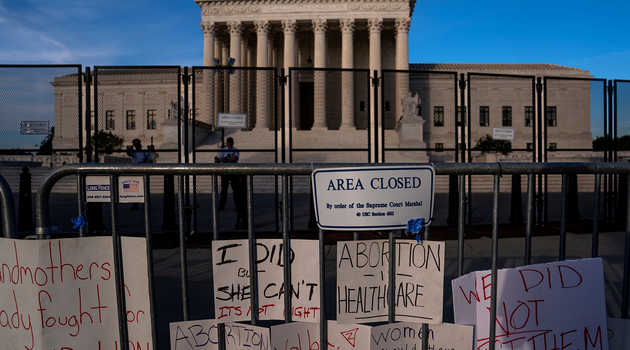 Signs left by abortion rights supporters line the security fence surrounding the Supreme Court in Washington, D.C., June 28, 2022. (Nathan Howard/Getty Images)