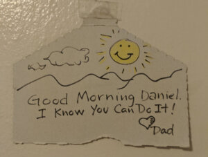 A hand-drawn sun, clouds, and the words" Good Morning Daniel. I Know You Can Do It! Dad'