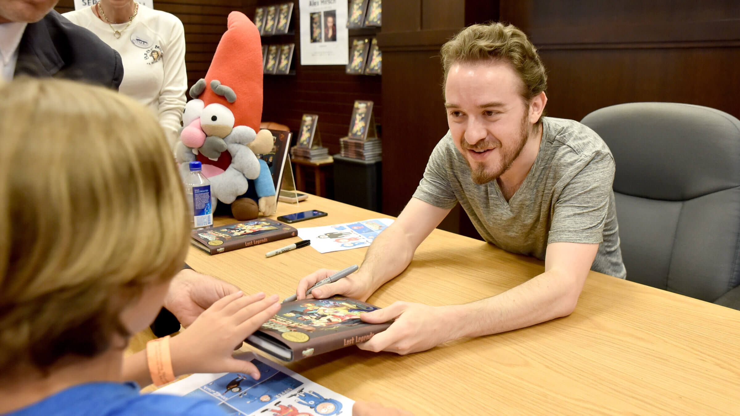 “Gravity Falls” creator Alex Hirsch signs copies of his book, “Gravity Falls: Lost Legends” in 2018.