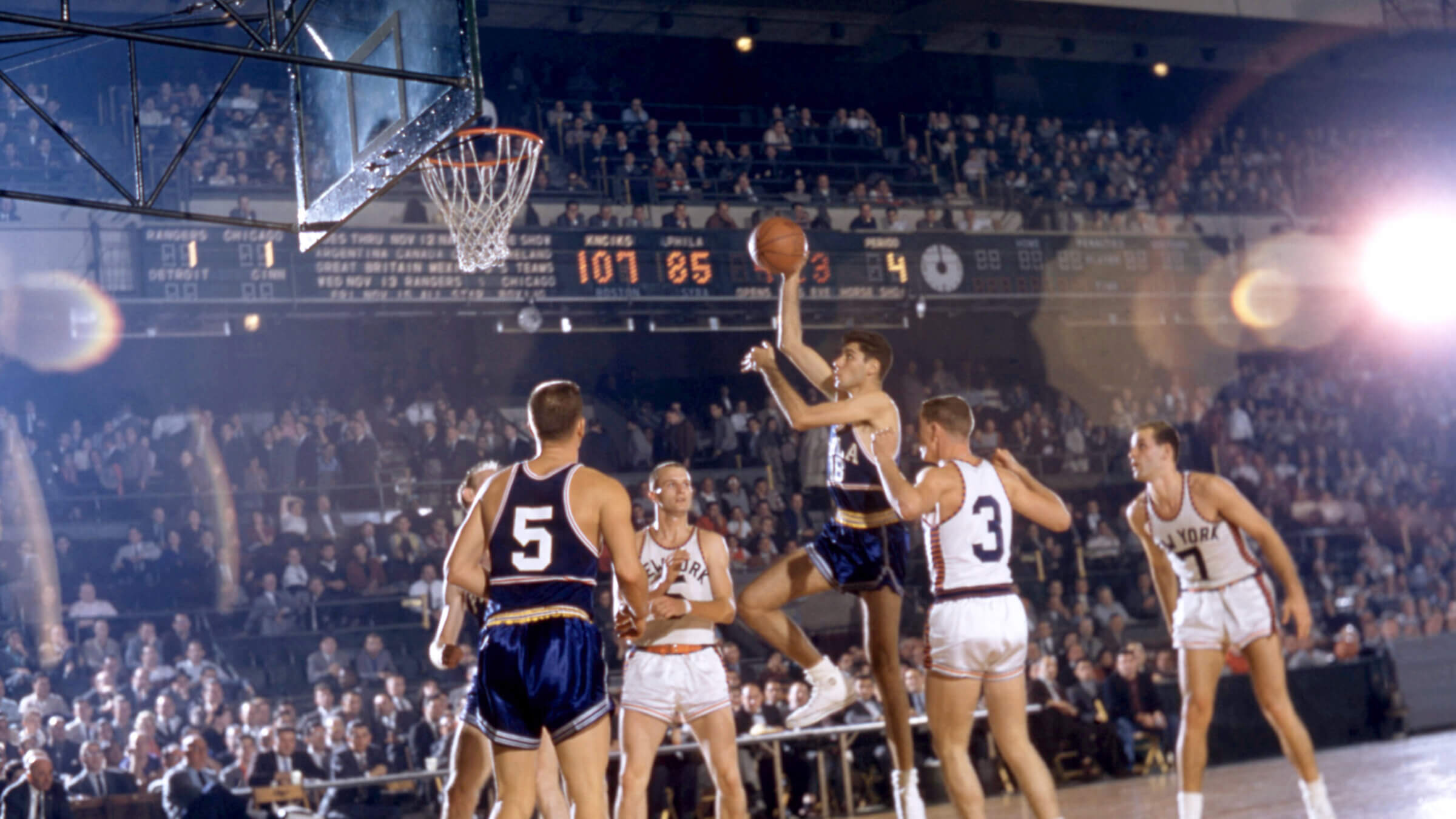 Lennie Rosenbluth, #18 of the Philadelphia Warriors, shoots in a 1957 game at Madison Square Garden. 