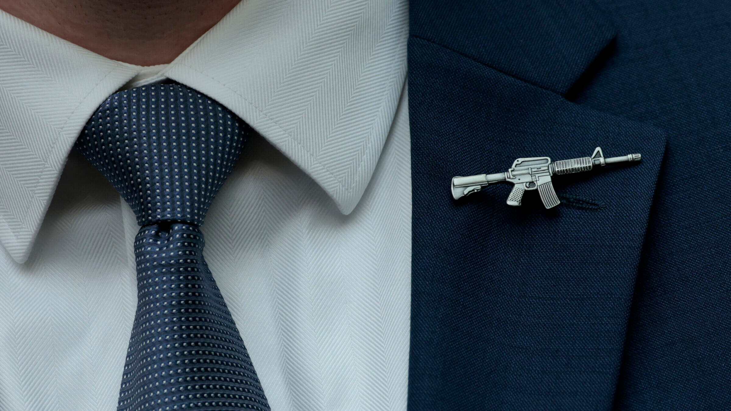 A congressional staffer wears a rifle-shaped pin on his suit during a House Judiciary Committee markup hearing in the Rayburn House Office Building on June 2, 2022, in Washington, D.C.
