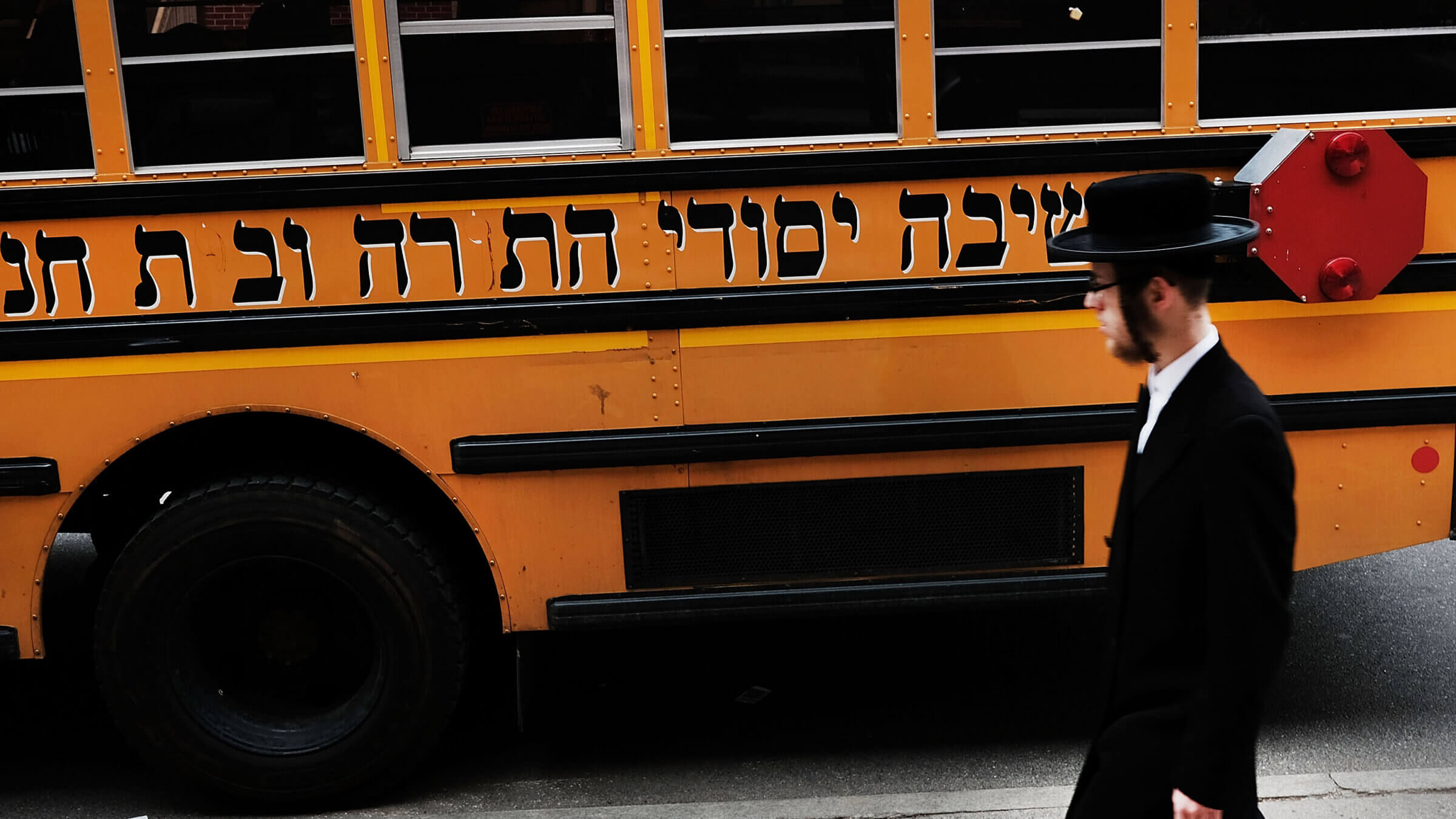 A Hasidic man walks through a Jewish Orthodox neighborhood in Brooklyn