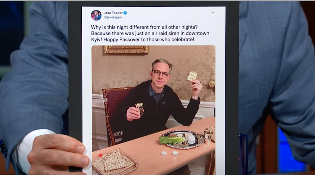 Stephen Colbert holds an image of Jake Tapper celebrating Passover in Kyiv, during a June 7 episode of “The Late Show with Stephen Colbert.” (Screenshot)